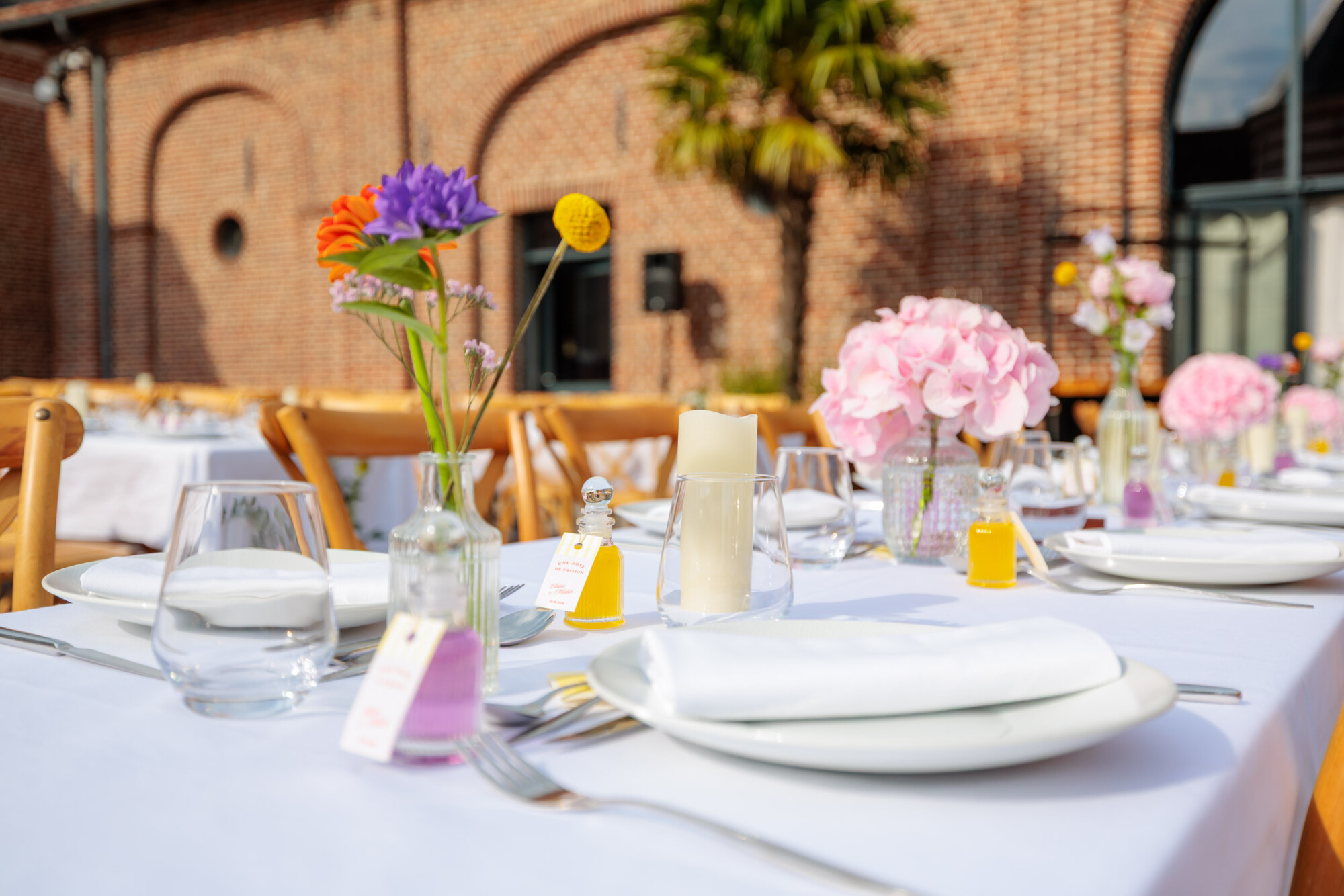 Table de réception fleurie dressée en extérieur pour organiser un mariage sur plusieurs jours au Domaine de la Traxène.